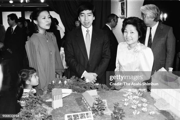 Prince Takamado, Princess Hisako and their daughter Princess Tsuguko visit a confectionery exhibition at Daimaru Museum on February 11, 1991 in...