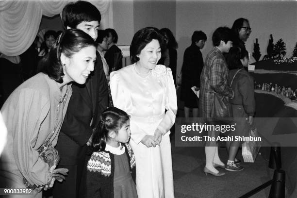 Prince Takamado, Princess Hisako and their daughter Princess Tsuguko visit a confectionery exhibition at Daimaru Museum on February 11, 1991 in...