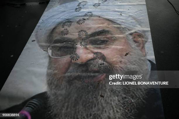Picture shows a portrait of Iranian President Hassan Rouhani with shoe marks over it during a demonstration in support of the Iranian people amid a...