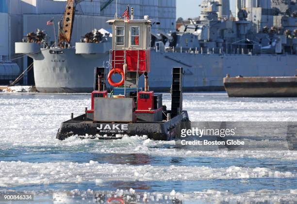 Small tug boat breaks up ice in the Fore River in Weymouth, MA on Jan. 2, 2018.