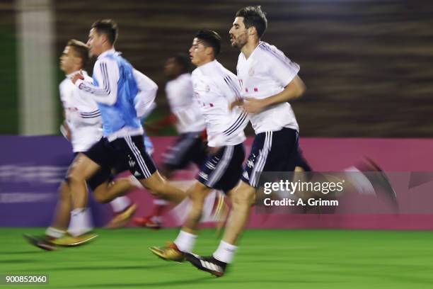 Javi Martinez and team mates run during a training session on day 2 of the FC Bayern Muenchen training camp at ASPIRE Academy for Sports Excellence...