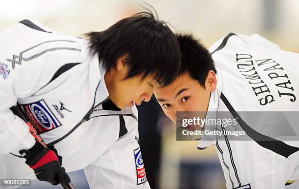 Kosuke Morozumi and Tetsuro Shimizu of Japan compete in the Men's Curling during day five of the Winter Games NZ at Maniototo Ice Rink on August 26,...