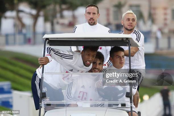 Kingsley Coman, Javi Martinez, James Rodriguez , Franck Ribery and Rafinha drive in a golf cart on their way to a training session on day 2 of the FC...