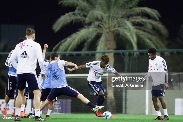 Kingsley Coman is challenged by Sebastian Rudy during a training session on day 2 of the FC Bayern Muenchen training camp at ASPIRE Academy for...