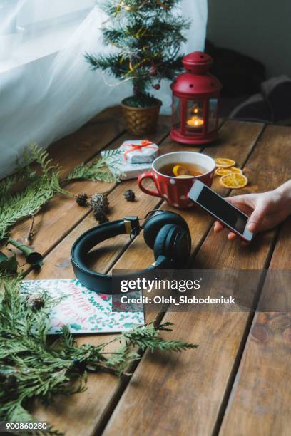 smartphone und kabellose kopfhörer auf die weihnachtszeit dekoriert tabelle - bluetooth stock-fotos und bilder