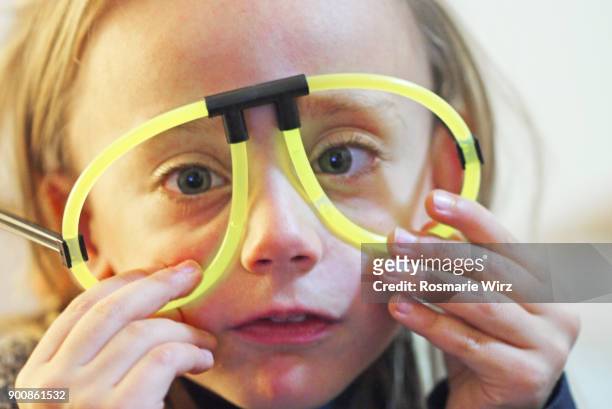 girl of five wearing phosphorescent party fun glasses - phosphorescence stock pictures, royalty-free photos & images