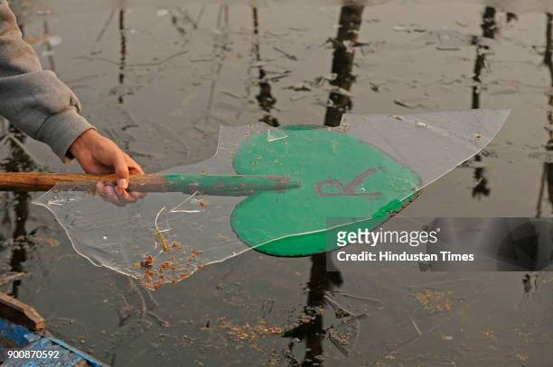 Kashmiri boatman shows a piece of frozen ice in the interiors of Nigeen Lake on January 3, 2018 in Srinagar, India. The weather in the region...