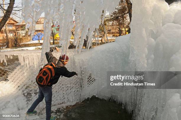 Icicles formed by the leakage of a water pipe are seen on January 3, 2018 in Tanmarg, about 34 kms North of Srinagar, India. The weather in the...