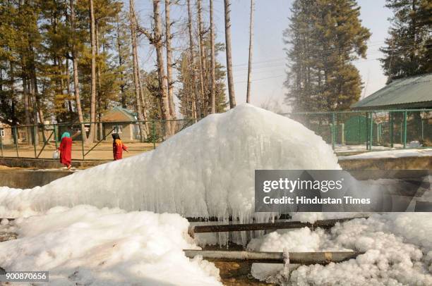 Icicles formed by the leakage of a water pipe are seen on January 3, 2018 in Tanmarg, about 34 kms North of Srinagar, India. The weather in the...