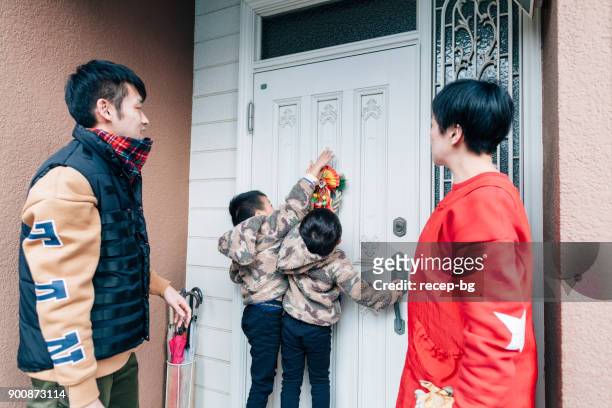 japanese family decorating house for new year - 2 5 months stock pictures, royalty-free photos & images