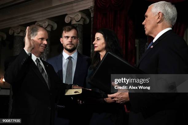 Sen. Doug Jones participates in a mock swearing-in ceremony with Vice President Mike Pence as Jones' wife Louise and son Carson look on at the Old...