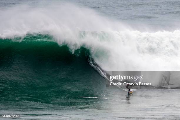 Chilean Rafael Tapia big wave surfer drops a wave during a surf session at Praia do Norte on January 3, 2018 in Nazare, Portugal.