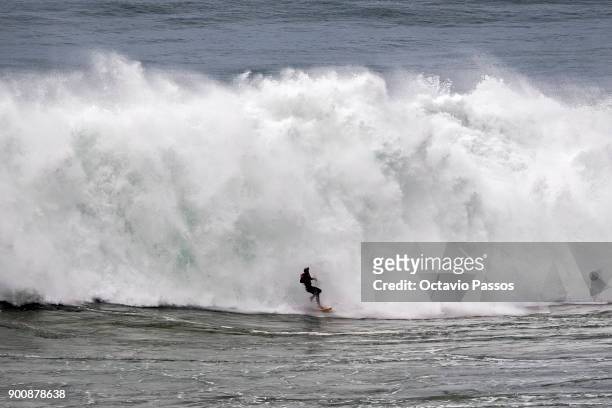 Chilean Rafael Tapia big wave surfer drops a wave during a surf session at Praia do Norte on January 3, 2018 in Nazare, Portugal.