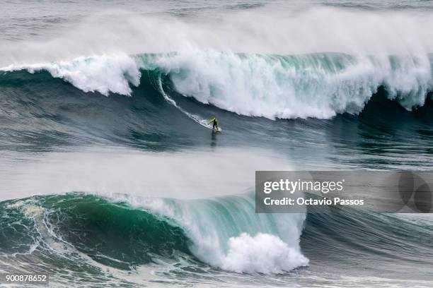 American David Langer big wave surfer drops a wave during a surf session at Praia do Norte on January 3, 2018 in Nazare, Portugal.