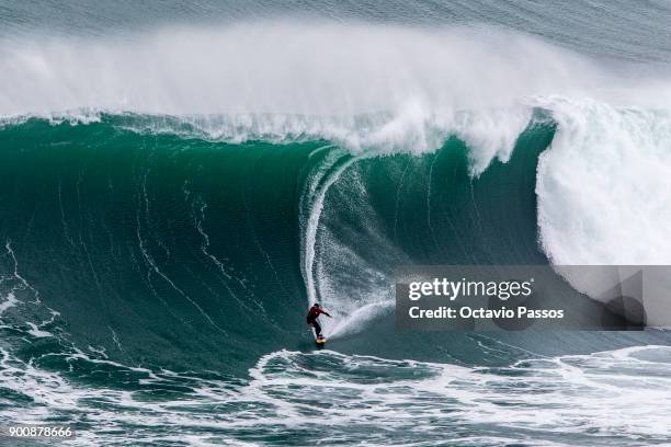 Chilean Rafael Tapia big wave surfer drops a wave during a surf session at Praia do Norte on January 3, 2018 in Nazare, Portugal.