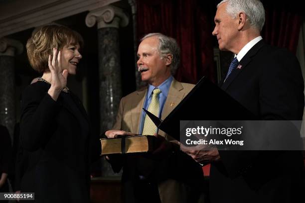 Sen. Tina Smith and her husband Archie Smith participate in a mock swearing-in ceremony with Vice President Mike Pence at the Old Senate Chamber of...