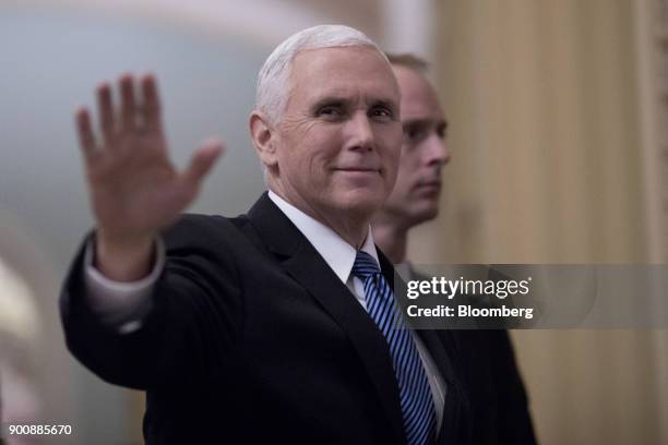 Vice President Mike Pence waves while arriving to a swearing in ceremony in the Old Senate Chamber of the U.S. Capitol in Washington, D.C, U.S., on...