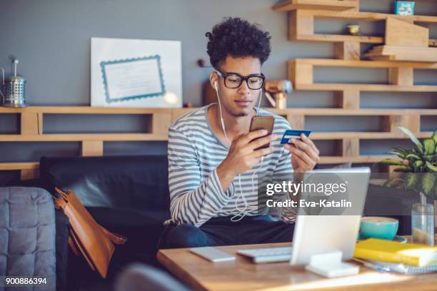 young man working at home office - home shopping stock pictures, royalty-free photos & images