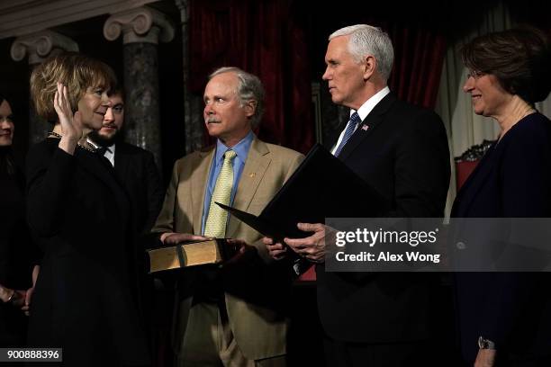 Sen. Tina Smith and her husband Archie Smith participate in a mock swearing-in ceremony with Vice President Mike Pence as Sen. Amy Klobuchar looks on...