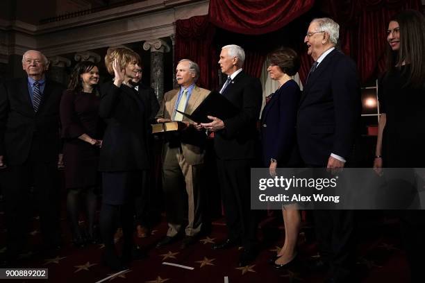 Sen. Tina Smith and her husband Archie Smith participate in a mock swearing-in ceremony with Vice President Mike Pence as Sen. Amy Klobuchar and...