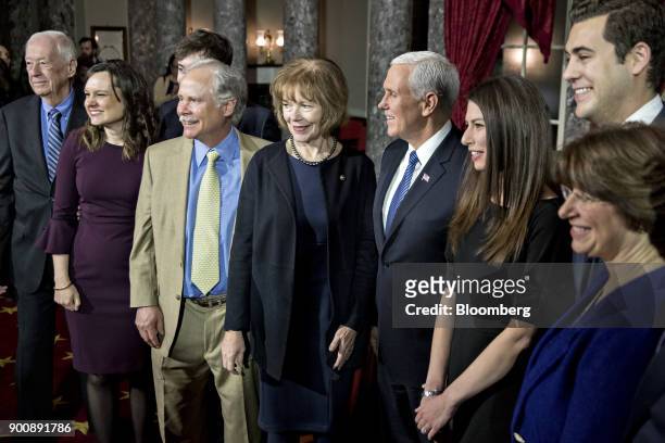 Senator Tina Smith, a Democrat from Minnesota, center, stands for a photograph with husband Archie Smith, third left, after being sworn-in by U.S....