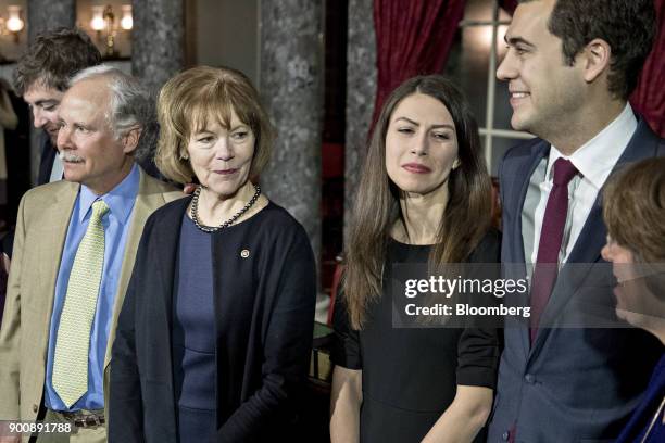 Senator Tina Smith, a Democrat from Minnesota, second left, stands during a photograph with husband Archie Smith, left, after being sworn-in by U.S....