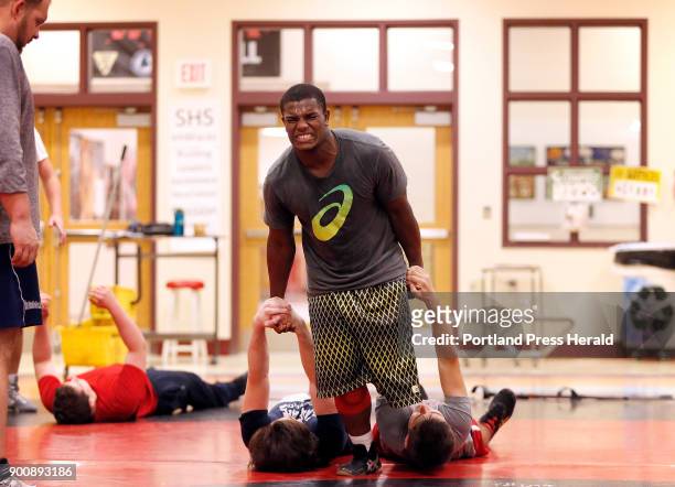 Scarborough wrestler Sam Leishman, center, drags teammates across the mat during a recent practice and a form of makeshift weight training. Leishman,...