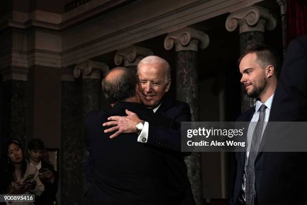 Former U.S. Vice President Joseph Biden gives U.S. Sen. Doug Jones a hug as Jones' son Carson looks on during a mock swearing-in ceremony at the Old...