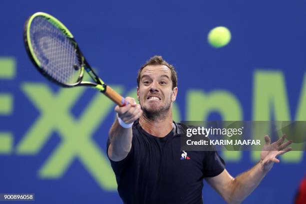 France's Richard Gasquet returns the ball to Greece's Stefanos Tsitsipas during the round of 16 in the ATP Qatar Open tennis competition in Doha on...