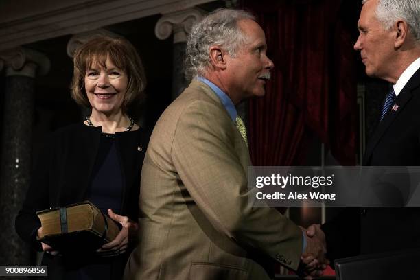 Sen. Tina Smith looks on as her husband Archie Smith greets Vice President Mike Pence during a mock swearing-in ceremony at the Old Senate Chamber of...