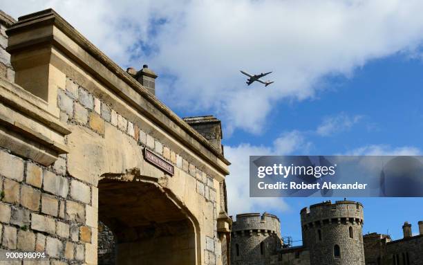 Virgin Airways passenger jet flies high over Windsor Castle in Windsor, England. Windsor Castle is a residence of the British royal family. Since the...