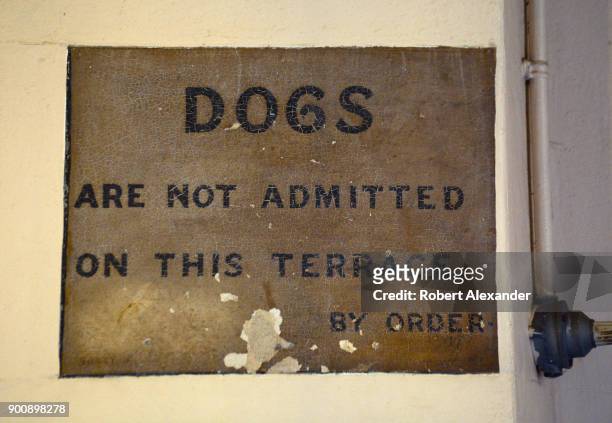 Vintage notice painted on a wall at Windsor Castle in Windsor, England, informs castle residents and visitors that dogs are not allowed on the...