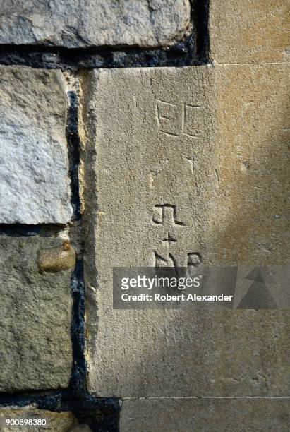 The initials 'JL' and 'MP' carved into a stone wall by vandals at Windsor Castle in Windsor, England. Windsor Castle is a residence of the British...