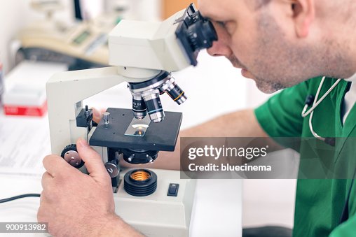 Microscope Man Man Scientist Examining Something Through A Microscope High-Res Stock ...