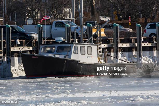 Sea ice surrounds a boat in Rock Harbor on January 3, 2018 in Orleans, Massachusetts, A winter storm is hitting the east coast from Florida to New...