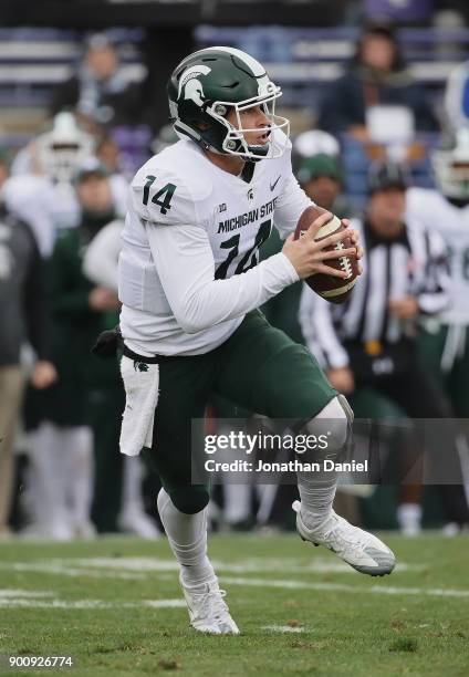 Brian Lewerke of the Michigan State Spartans runs against the Northwestern Wildcats at Ryan Field on October 28, 2017 in Evanston, Illinois....