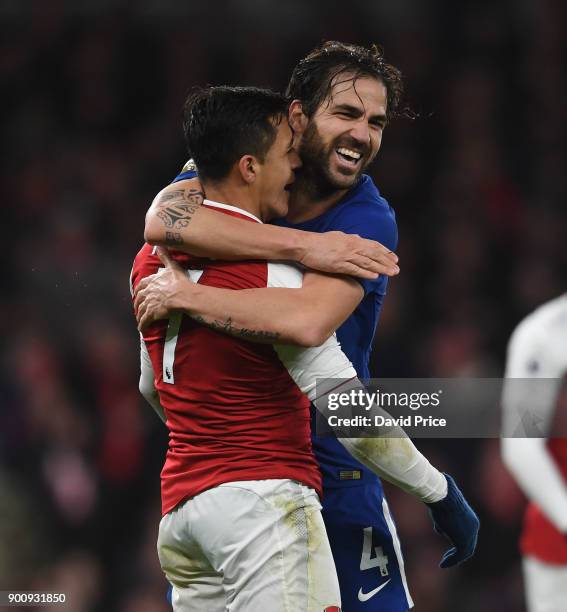 Alexis Sanchez of Arsenal is hugged by Cesc Fabregas of Chelsea during the Premier League match between Arsenal and Chelsea at Emirates Stadium on...