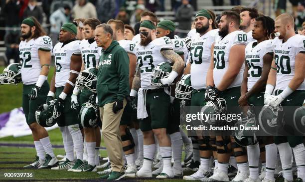 Head coach Mark Dantonio of the Michigan State Spartans stands with his team before a agem against the Northwestern Wildcats at Ryan Field on October...