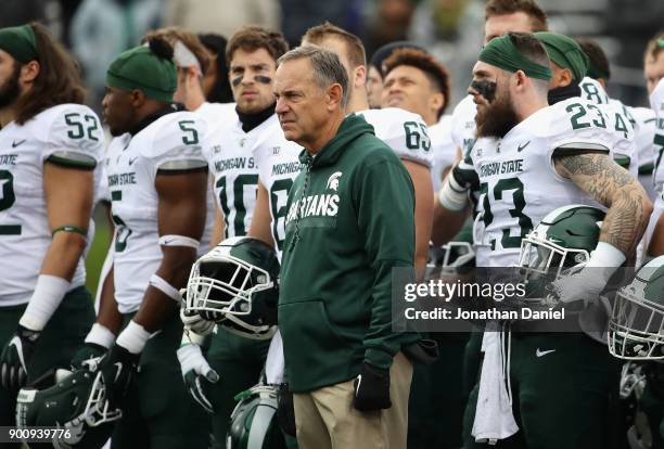 Head coach Mark Dantonio of the Michigan State Spartans stands with his team before a agem against the Northwestern Wildcats at Ryan Field on October...