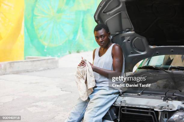 Gender fluid woman repairing car