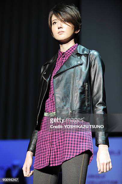 Model displays artficial leather jacket of Japanese casual apparel giant Uniqlo at their "neo leather" collection in Tokyo on August 26, 2009. Uniqlo...