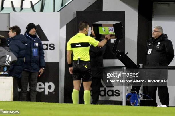 Referee Daniele Doveri checks the VAR during the TIM Cup match between Juventus and Torino FC at Allianz Stadium on January 3, 20
