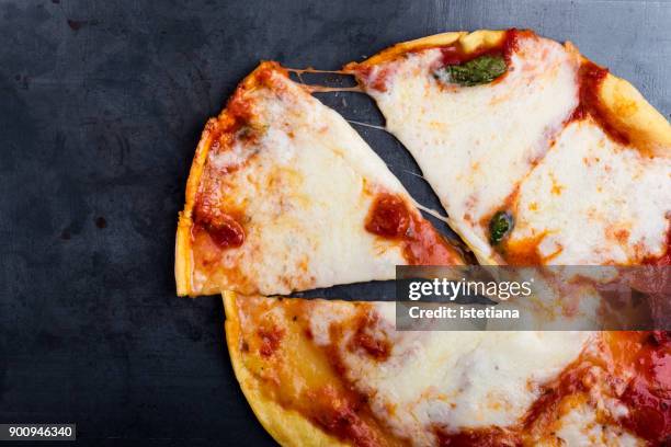 slice of traditional pizza margherita - cheese pizza stock-fotos und bilder