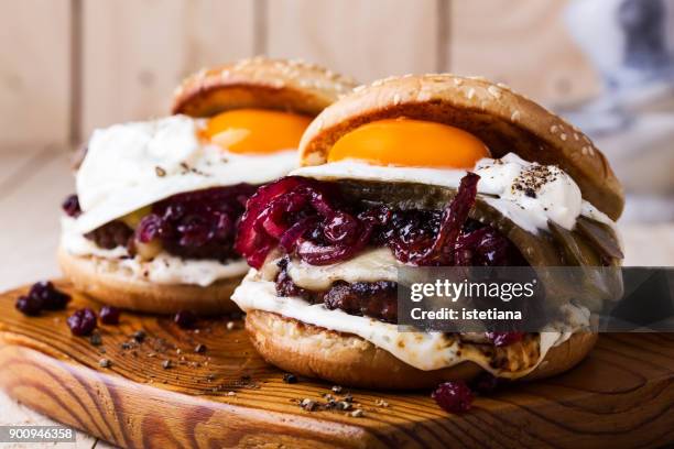 cheeseburger with caramelized onions, fried egg and aioli - juicy stock pictures, royalty-free photos & images