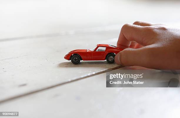 boy's hand playing with toy car on the floor,low a - toy car 個照片及圖片檔