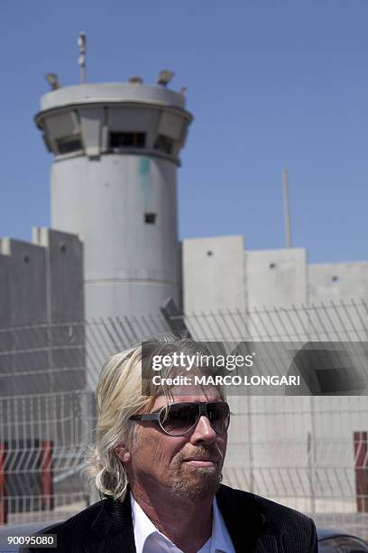 British Richard Branson, chairman of the Virgin Group and one of the founders of �The Elders�, stands near a section of Israel's separation barrier...
