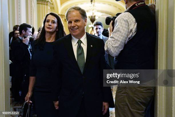 Sen. Doug Jones and his wife Louise arrive for a meeting with Senate Minority Leader Sen. Chuck Schumer at the U.S. Capitol January 3, 2018 in...