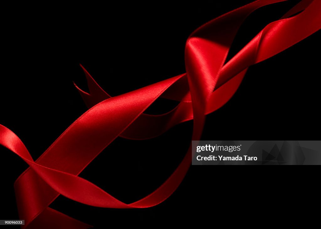 Red tangled ribbons on black back 