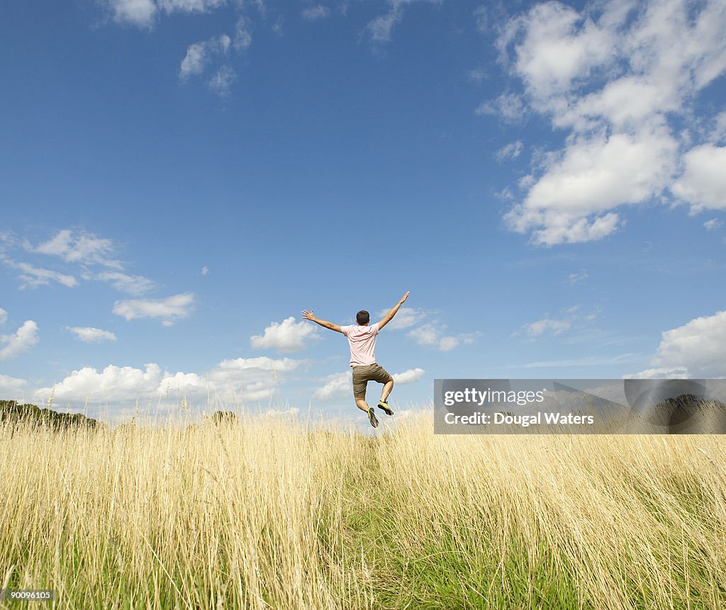 Young man jumping in countryside.