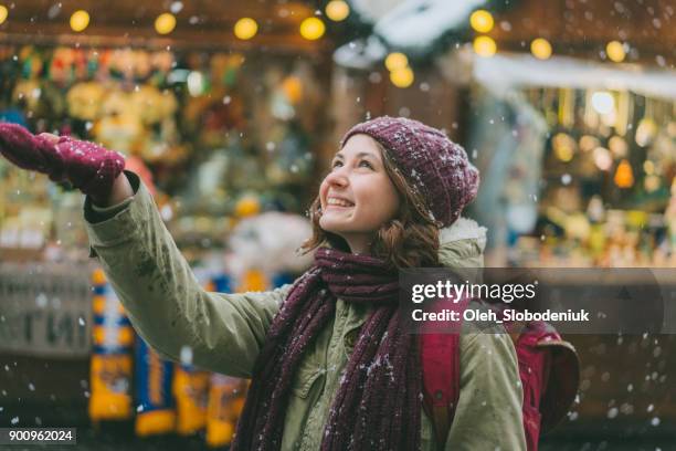 woman walking on christmas market - parka coat stock pictures, royalty-free photos & images